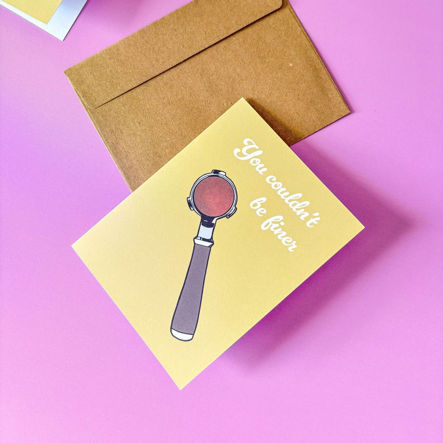 Greeting card with espresso portafilter illustration and envelope on a pink background