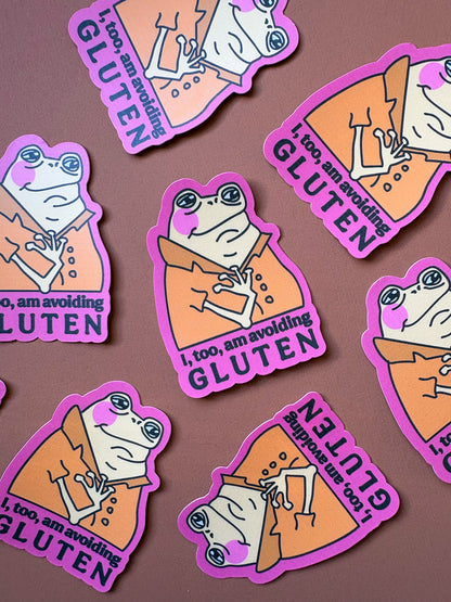 Front view of the pink-bordered frog sticker held in a hand