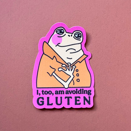 Frog sticker with orange shirt and pink border reading I, too, am avoiding GLUTEN, on a pink background
