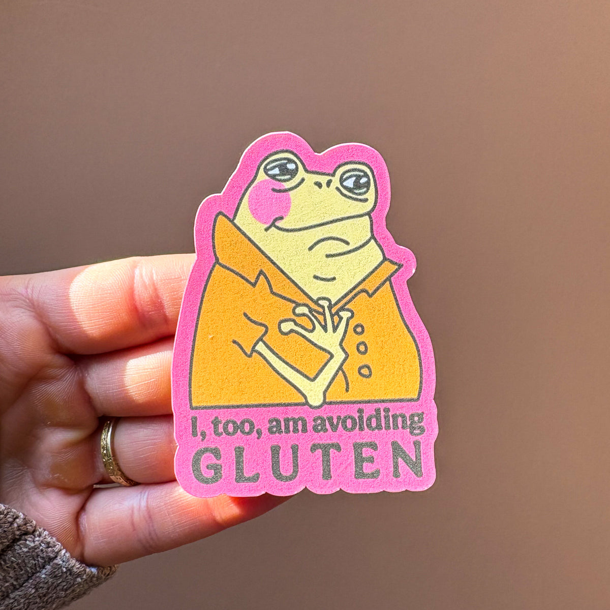 Several avoiding gluten frog stickers arranged on a pink background