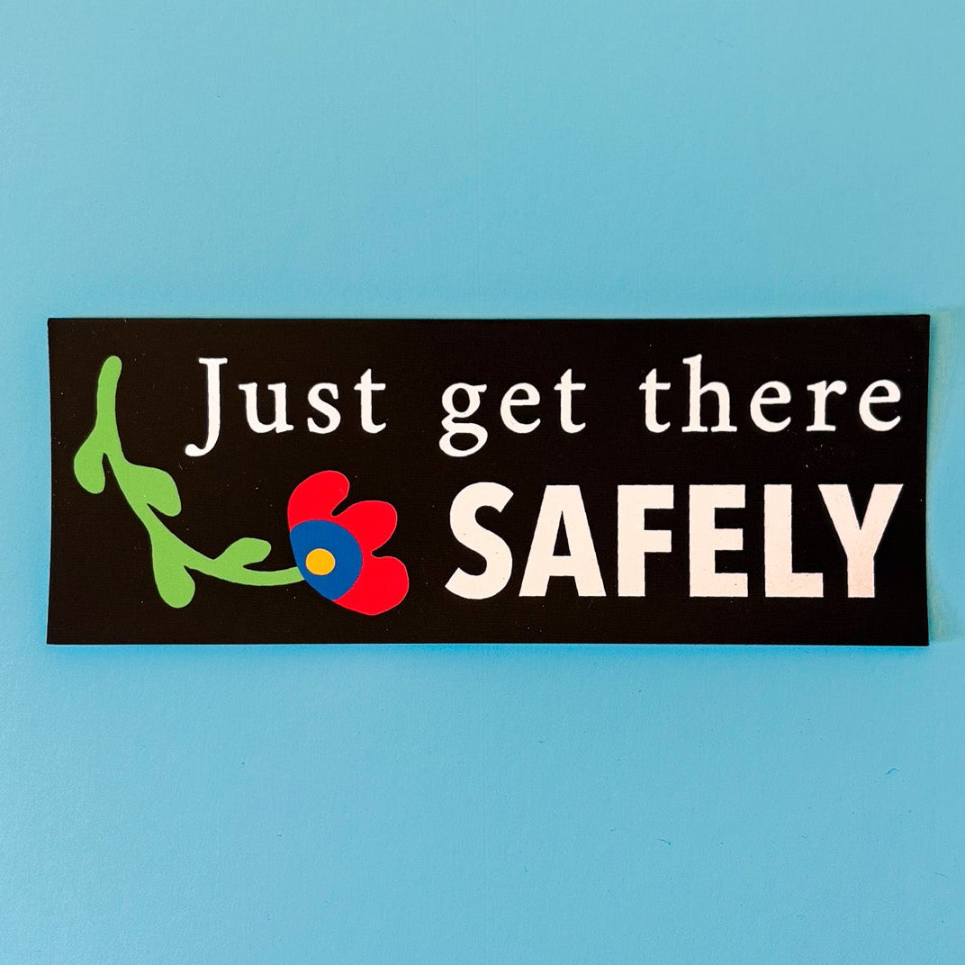 Black rectangular sticker with 'Just get there SAFELY' text on a blue background.