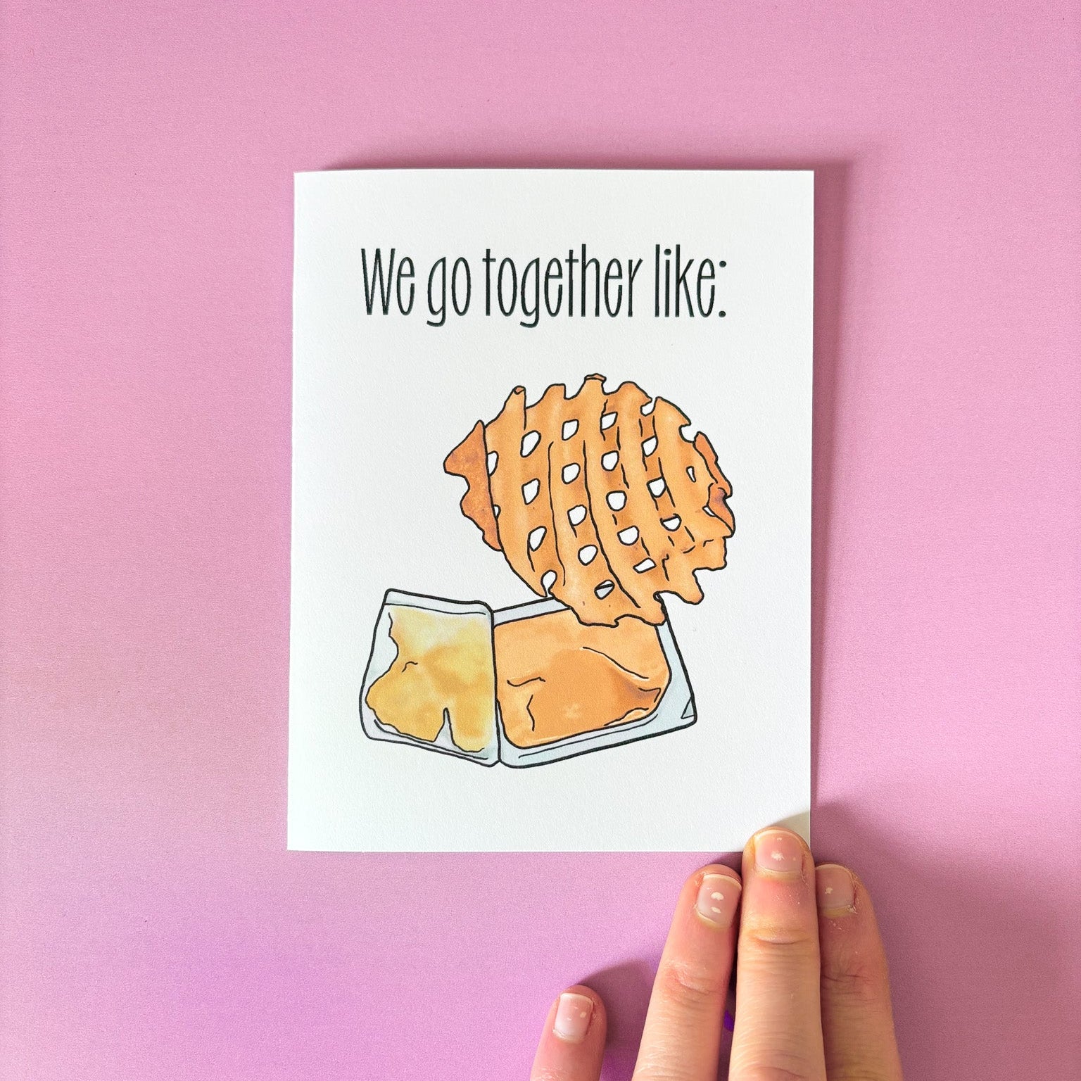 Card with waffle and sauce illustration and text 'We go together like:' on a pink background.