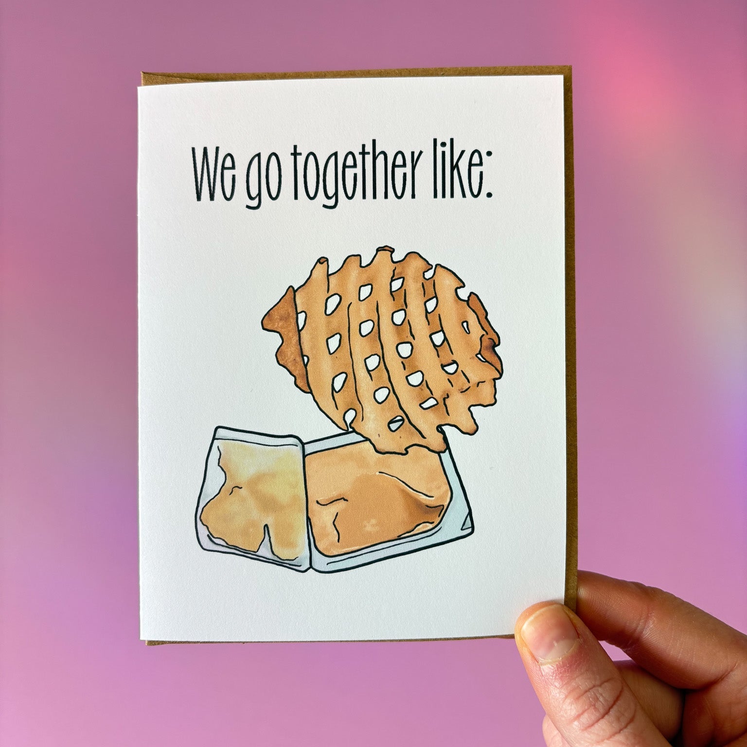 Card with waffle fry illustration and text 'We go together like:' held against a pink background.